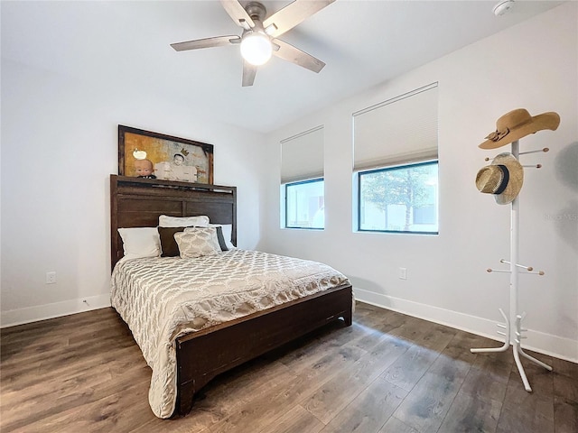 bedroom with ceiling fan and dark hardwood / wood-style flooring