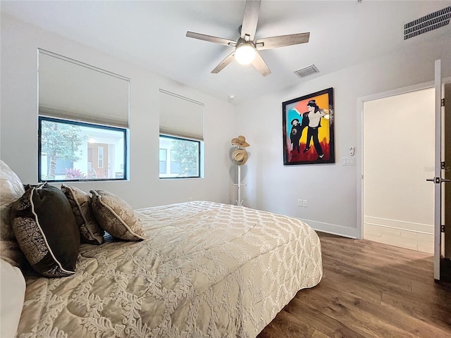 bedroom with ceiling fan and dark wood-type flooring