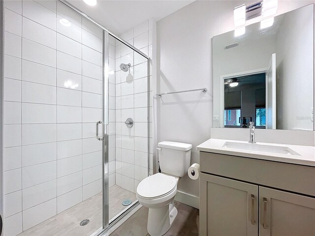 2511 N Grady Ave N Unit 59, Tampa, FL 33607 - full bathroom with toilet, vanity, a stall shower, and ceiling fan