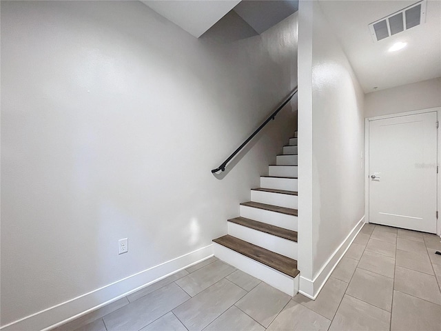 stairway with tile patterned flooring