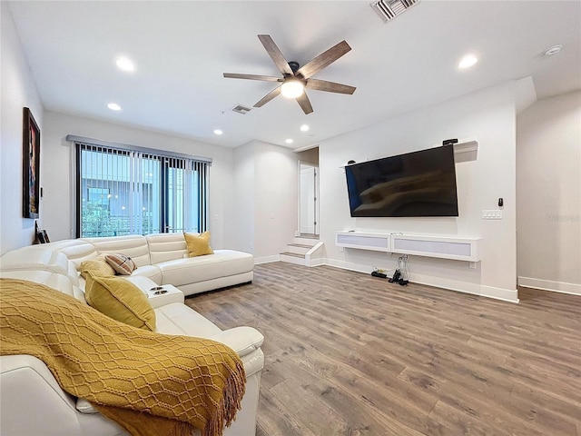 living room with hardwood / wood-style floors and ceiling fan