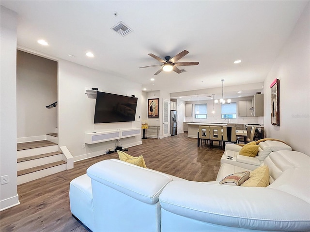 living room with ceiling fan and dark wood-type flooring