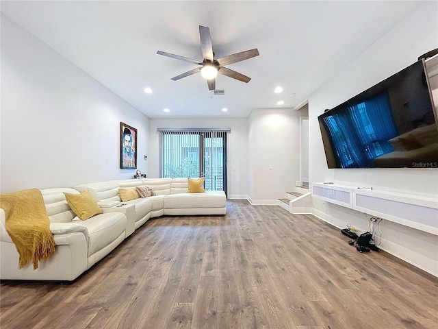 unfurnished living room featuring ceiling fan and hardwood / wood-style flooring