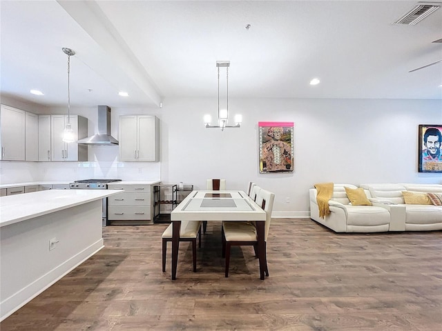 dining space featuring dark hardwood / wood-style floors and an inviting chandelier