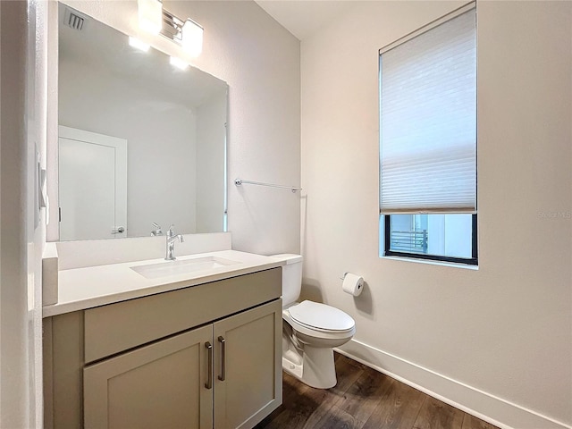 bathroom featuring hardwood / wood-style floors, vanity, and toilet