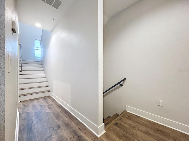 stairs with hardwood / wood-style flooring