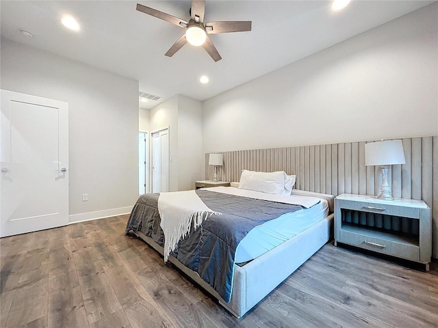 bedroom with ceiling fan, wood-type flooring, and a closet