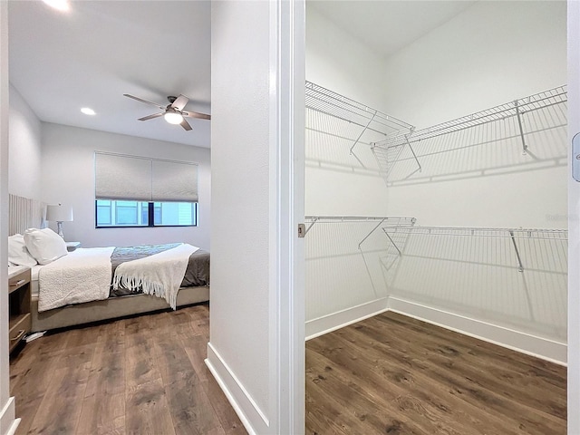 bedroom with dark hardwood / wood-style floors and ceiling fan