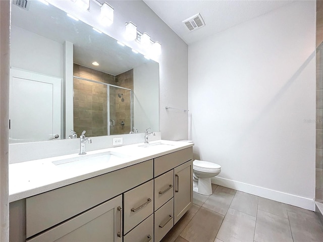 bathroom featuring tile patterned floors, vanity, toilet, and walk in shower