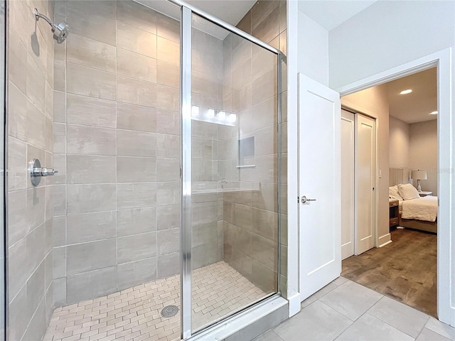 bathroom featuring an enclosed shower and hardwood / wood-style flooring