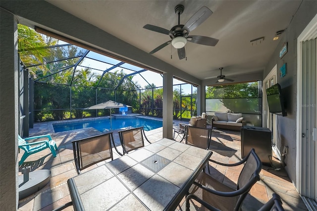 view of swimming pool with a lanai, ceiling fan, a patio, and an outdoor living space