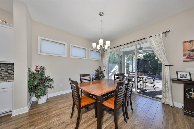 dining area featuring an inviting chandelier and dark wood-type flooring