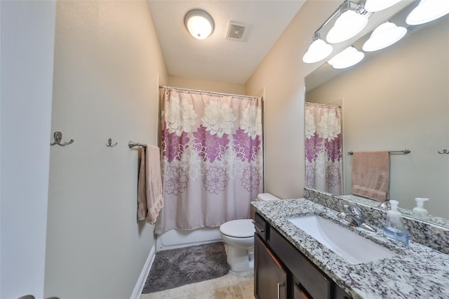 bathroom featuring tile patterned floors, vanity, toilet, and a textured ceiling