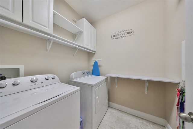 laundry room with cabinets and separate washer and dryer