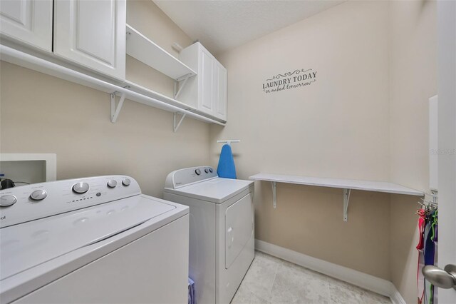 6337 Waves End Pl, Apollo Beach, FL 33572 - laundry area featuring washing machine and clothes dryer, cabinet space, baseboards, and light tile patterned floors