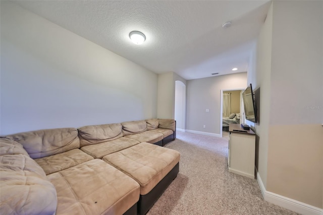 carpeted living room with a textured ceiling