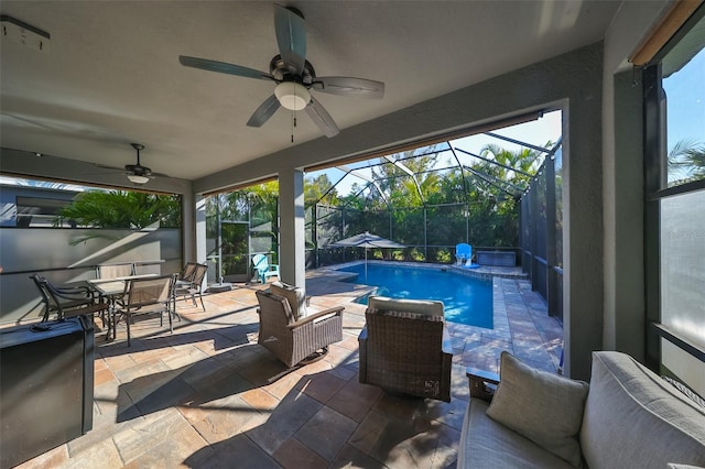 view of pool with a lanai, a patio area, ceiling fan, and an outdoor hangout area