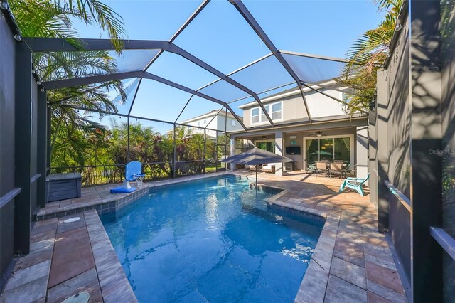 6337 Waves End Pl, Apollo Beach, FL 33572 - swimming pool with ceiling fan, a patio, and glass enclosure