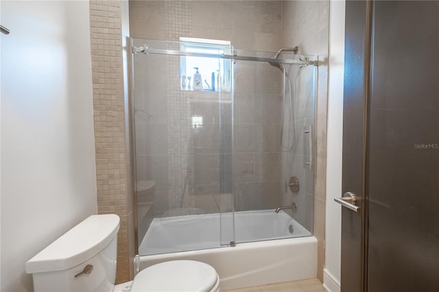 bathroom with enclosed tub / shower combo and toilet