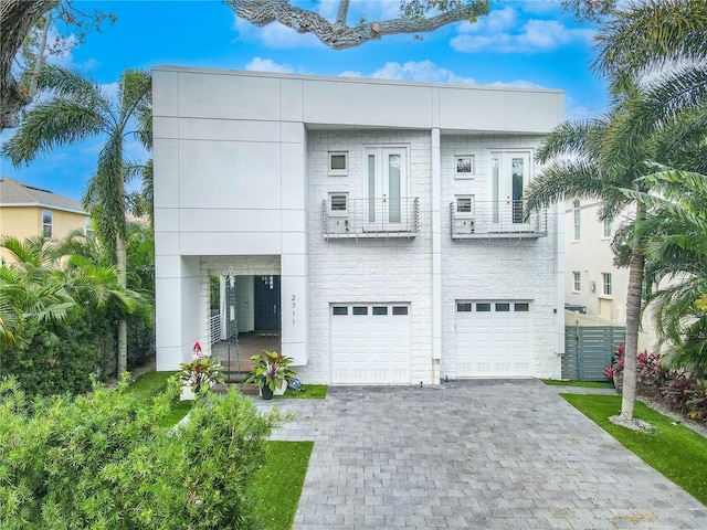 view of front of home featuring a garage and a balcony