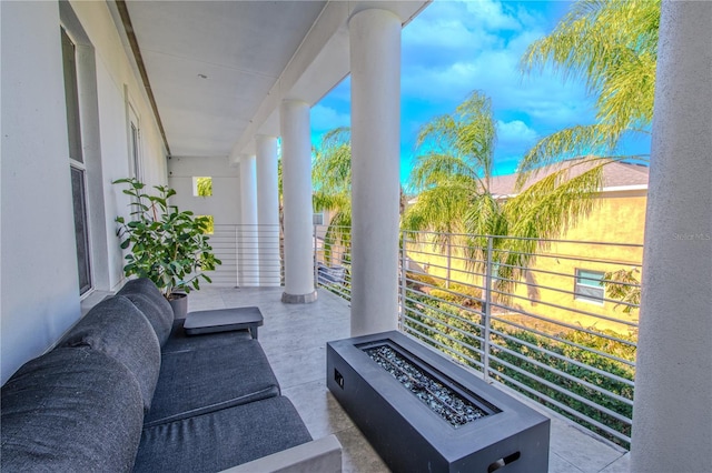 view of patio / terrace featuring a balcony and a fire pit