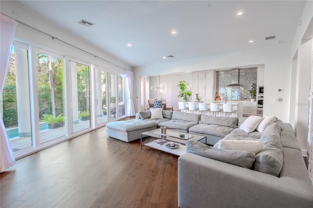 living room featuring dark hardwood / wood-style floors and a notable chandelier