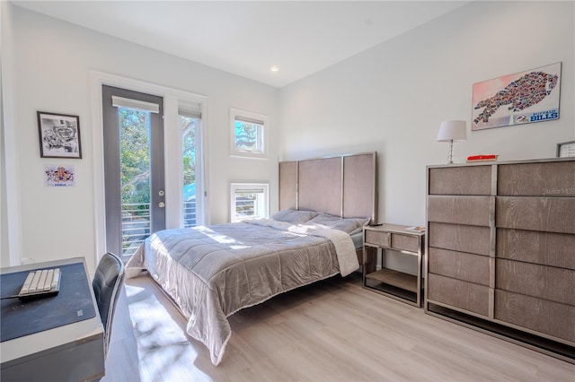 bedroom featuring access to exterior and light wood-type flooring