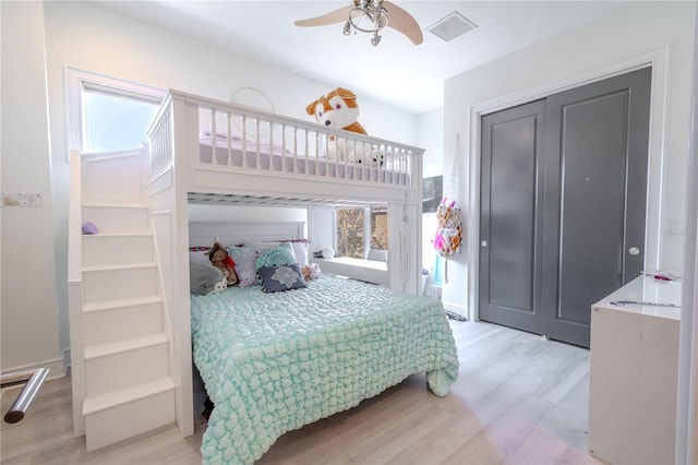 bedroom featuring light hardwood / wood-style floors, a closet, and ceiling fan