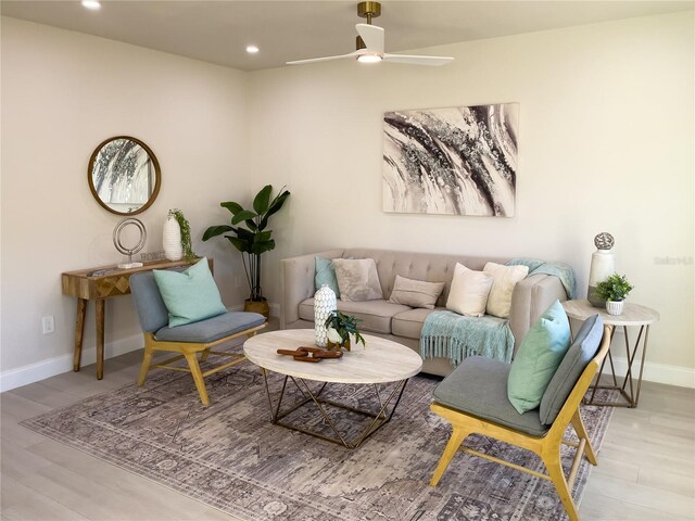 living room with light hardwood / wood-style floors and ceiling fan