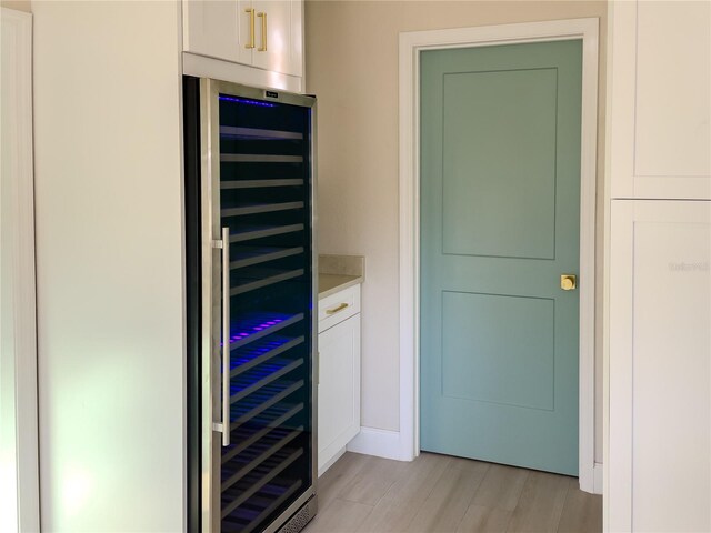 interior space with hardwood / wood-style flooring, wine cooler, and bar