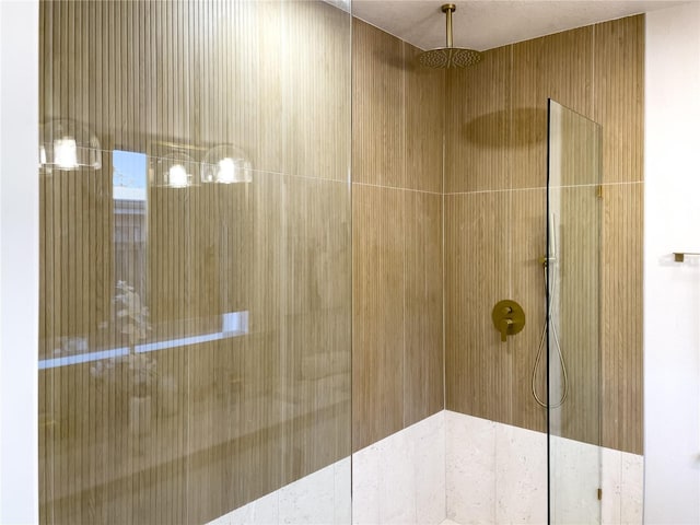 bathroom with tiled shower