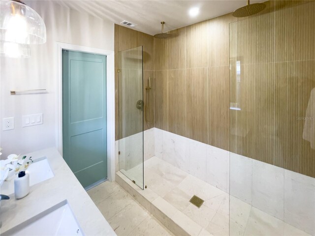 bathroom with sink and tiled shower