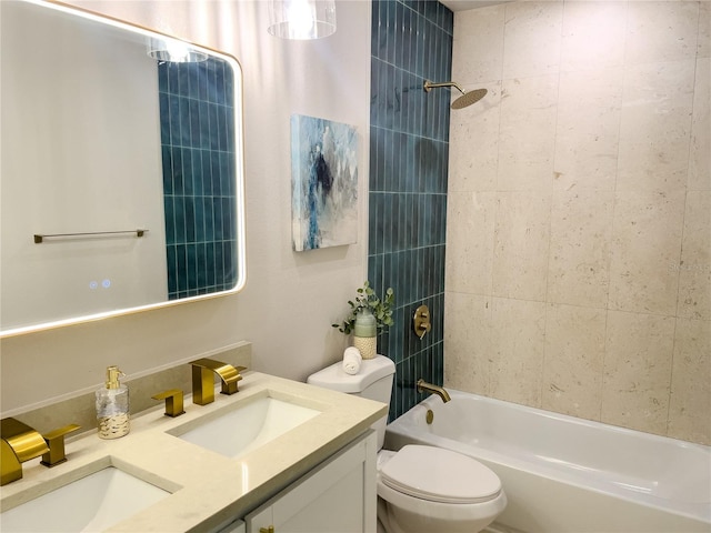 full bathroom featuring toilet, vanity, and tiled shower / bath