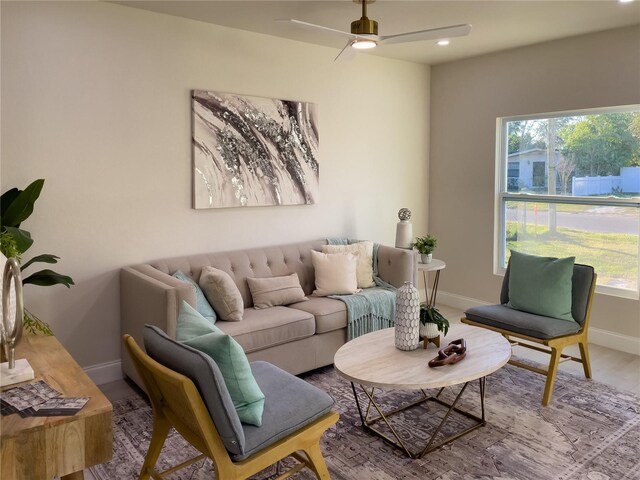 living room with a wealth of natural light, ceiling fan, and light hardwood / wood-style floors