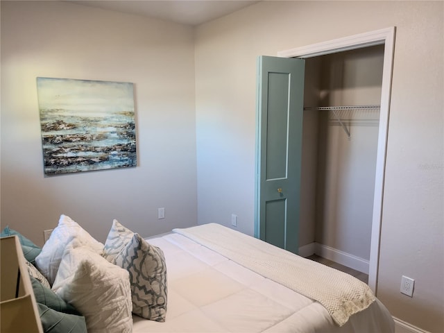 5516 Golden Dr, Tampa, FL 33634 - bedroom featuring a closet, baseboards, and wood finished floors