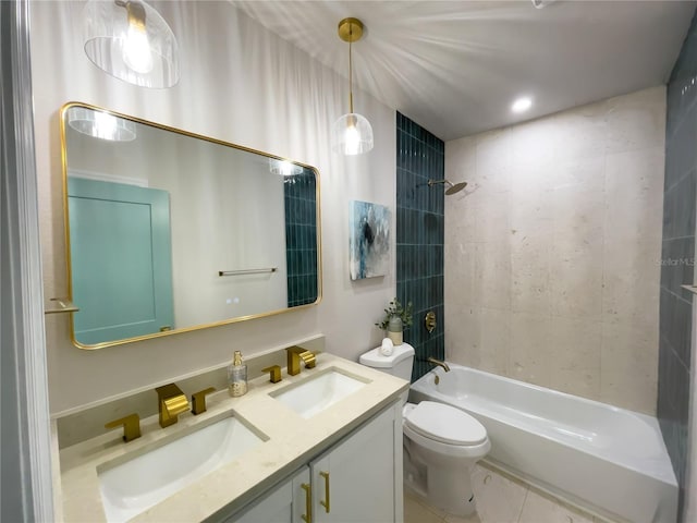 full bathroom featuring vanity, tiled shower / bath combo, and toilet