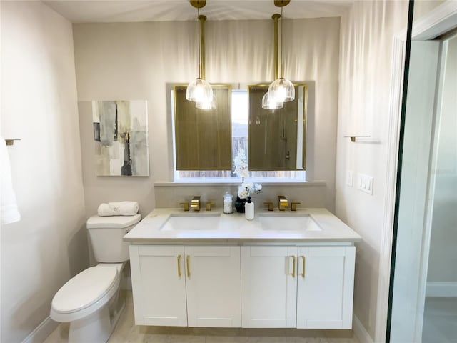 5516 Golden Dr, Tampa, FL 33634 - bathroom featuring double vanity and toilet