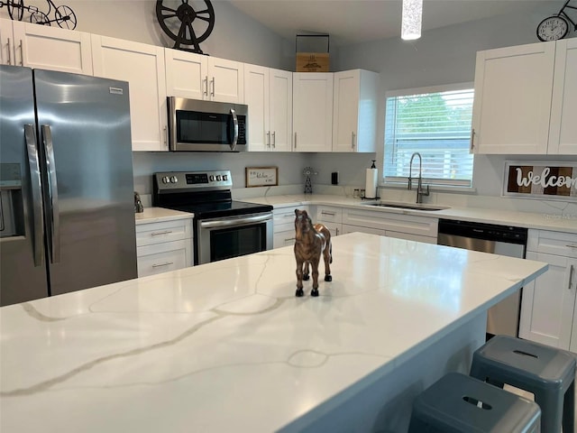 kitchen with white cabinets and appliances with stainless steel finishes