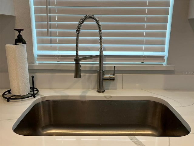 interior details with light stone counters and sink