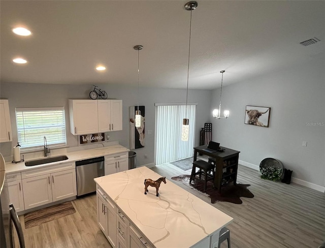 kitchen with white cabinets, dishwasher, pendant lighting, and sink