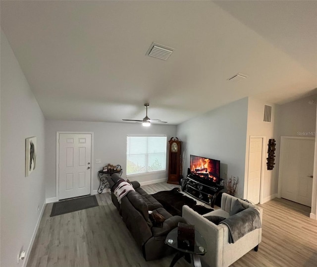 living room featuring light wood-type flooring and ceiling fan