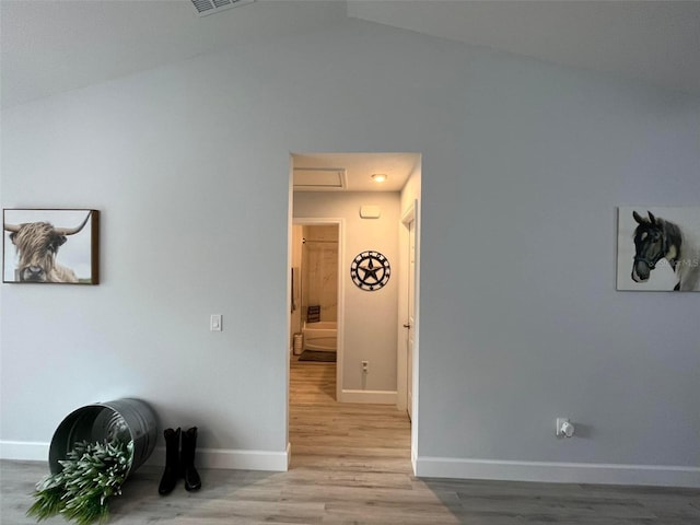 interior space with light wood-type flooring and lofted ceiling