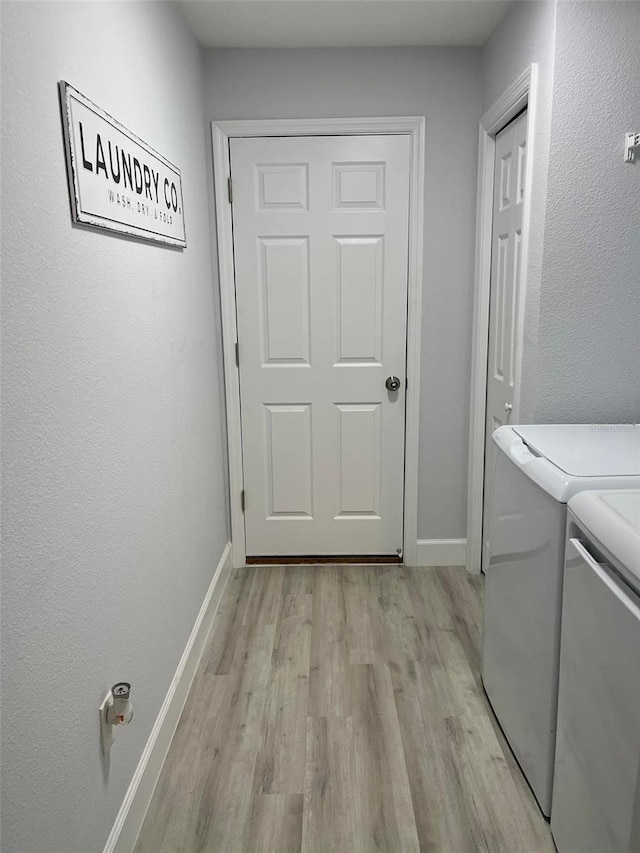 washroom featuring separate washer and dryer and light wood-type flooring