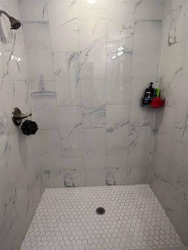 bathroom with a tile shower