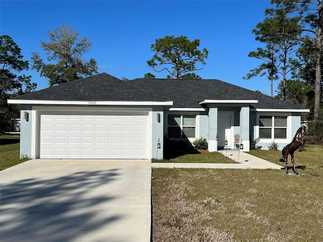 single story home featuring a garage and a front lawn