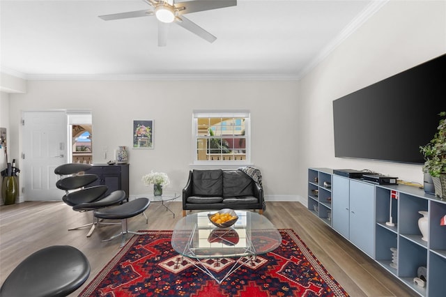 living room with ceiling fan, hardwood / wood-style floors, and ornamental molding