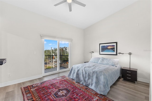 bedroom with access to exterior, ceiling fan, wood-type flooring, and lofted ceiling