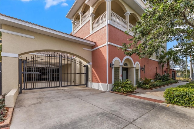 view of property with driveway and fence