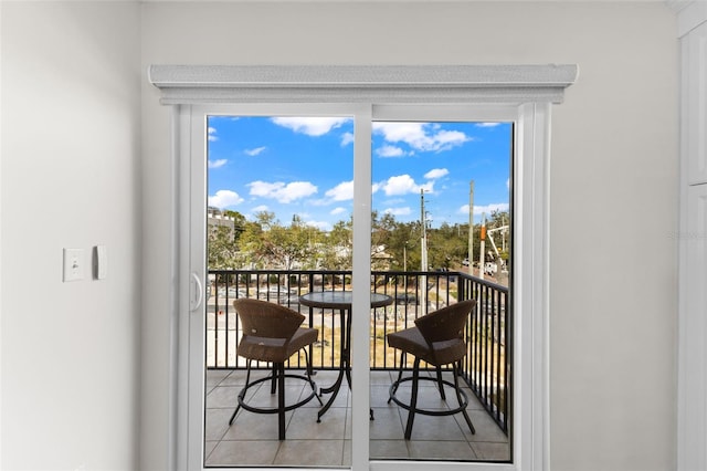 doorway to outside with light tile patterned flooring