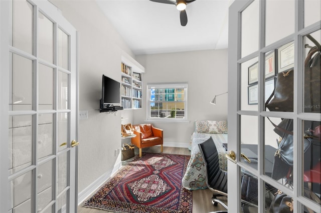 office area with a ceiling fan, wood finished floors, baseboards, and french doors
